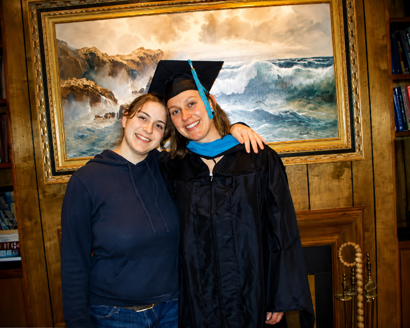 Tiffany wearing her University of Louisville graduation gown with her sister Alyssa after earning her Master of Public Administration degree in 2008
