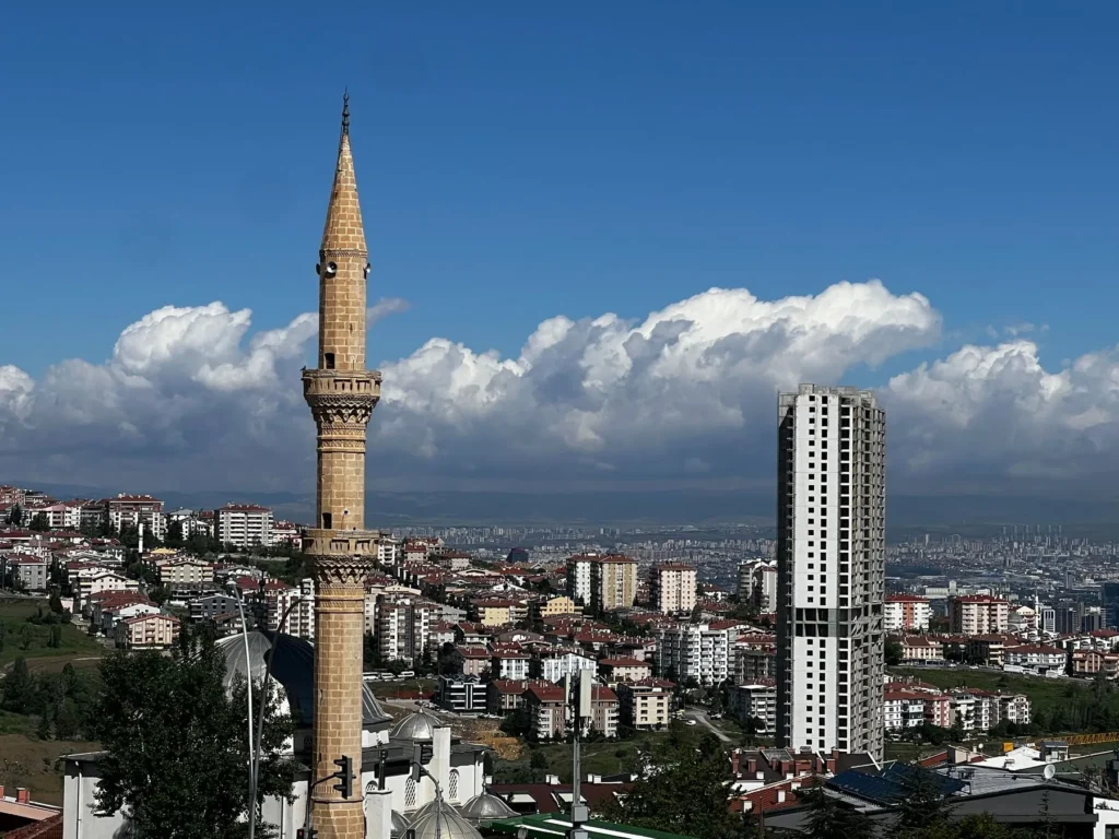Ankara neighborhoods spreading across the hills beside a mosque minaret