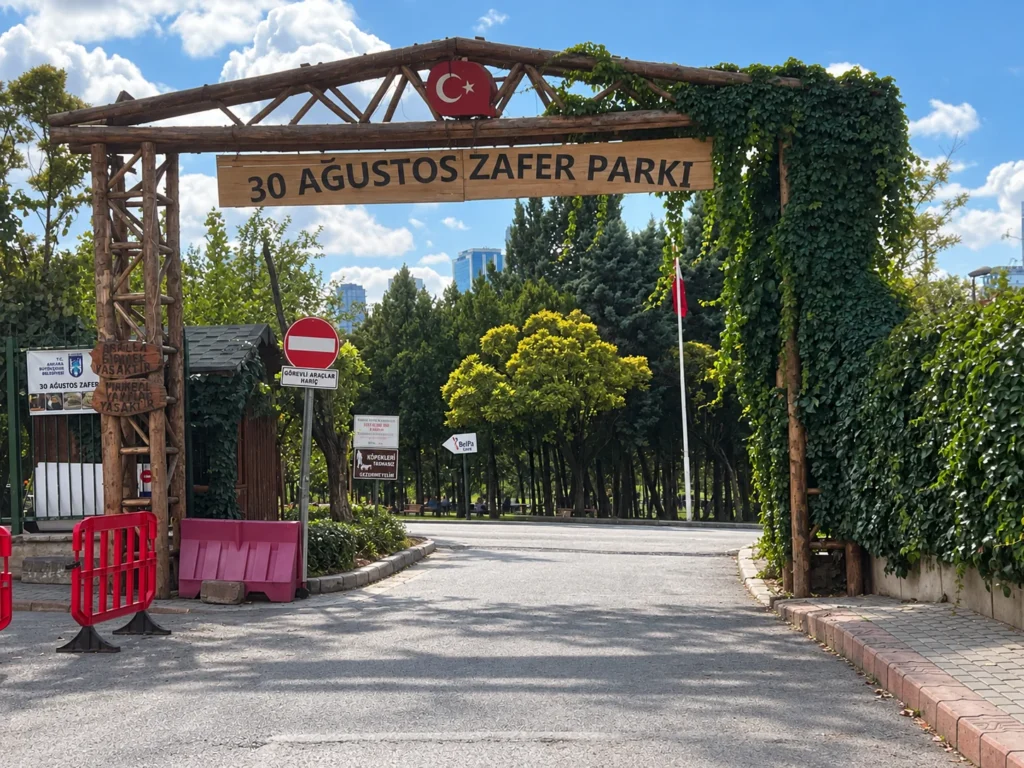 Wooden entrance arch with a Turkish crescent and star above the sign for 30 Ağustos Zafer Parkı.