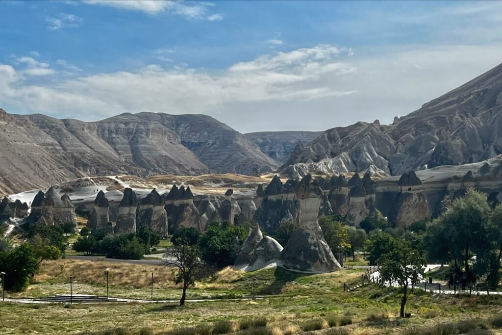 Rock formations and carved dwellings across the landscape near Göreme Open-Air Museum in Cappadocia, Türkiye.