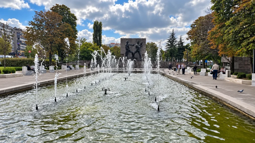 Rows of fountain jets lead across a rectangular pool toward Güvenpark’s monument in Ankara.