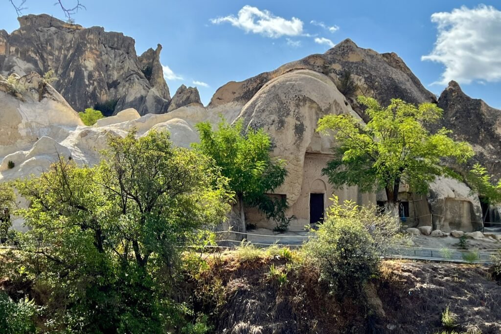 Exterior of Karanlık Kilise, the Dark Church, carved into volcanic rock at Göreme Open-Air Museum in Cappadocia, Türkiye.