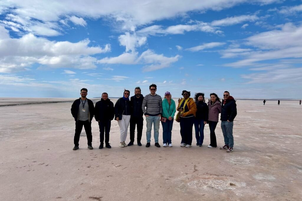 Toastmasters friends standing together on the salt flats of Tuz Gölü during a weekend trip from Ankara to Cappadocia